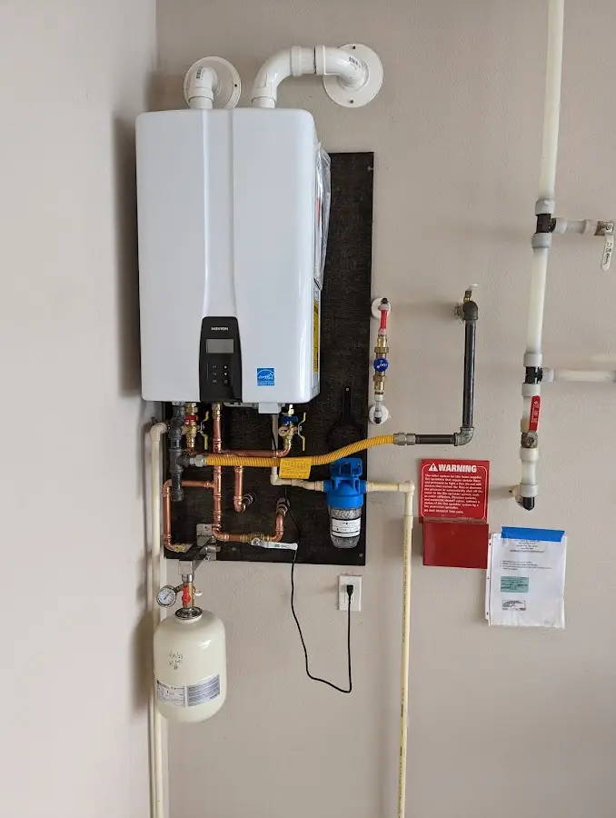 Professional plumber installing copper piping in a Bell home